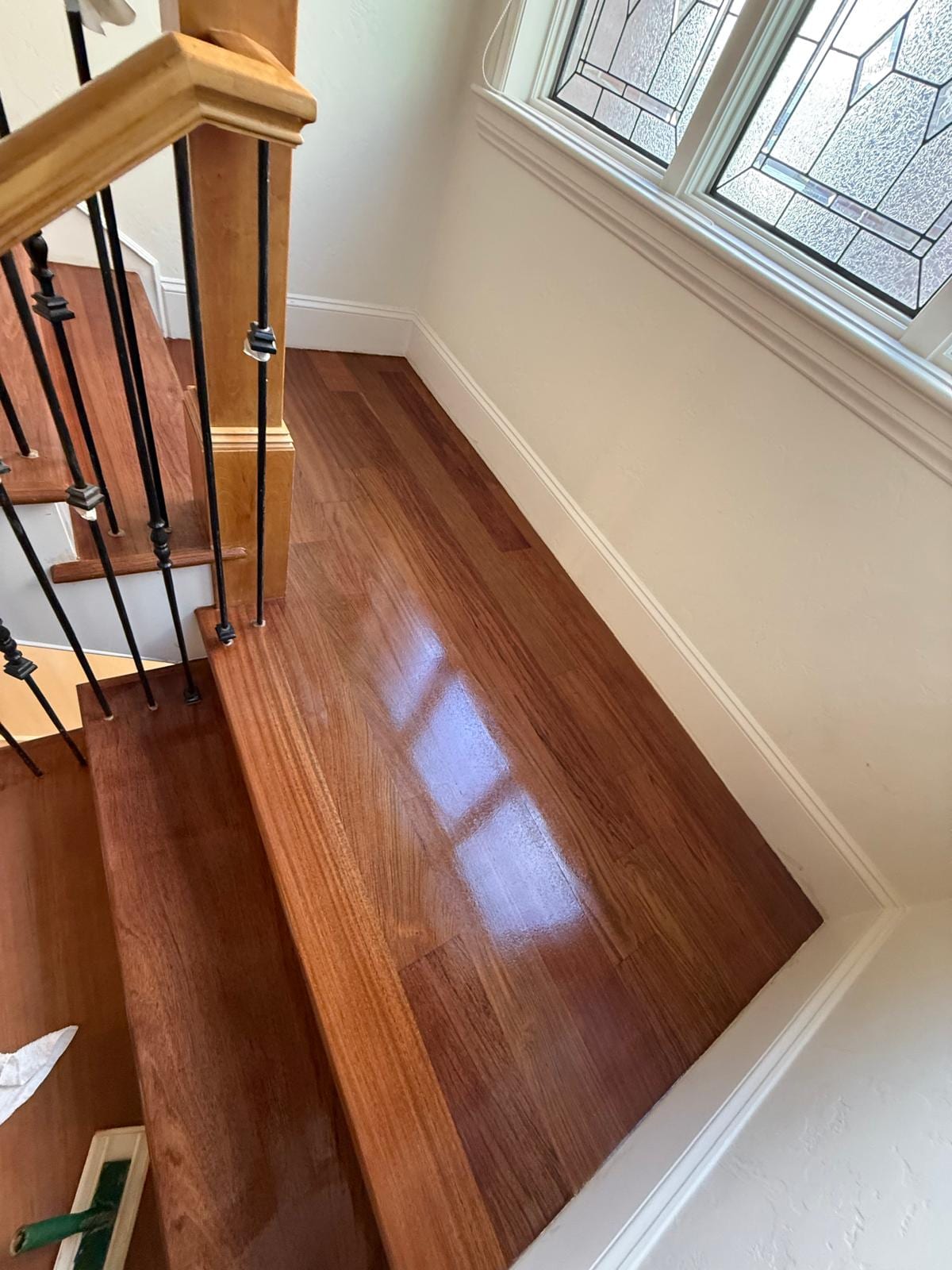 Hallway with refinished hardwood flooring in a rich, dark cherry tone